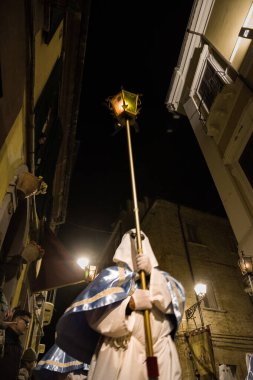 Chieti, Italy - 29 march 2024: Hooded penitents during the famous Good Friday procession in Chieti (Italy) with the luminous lantern clipart