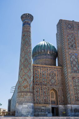 Tower decorated with mosaics in the Registan square in Samarkand clipart