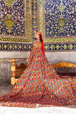 Samarkand, Uzbekistan - 05 July 2024: Woman in traditional Uzbek long dress clipart