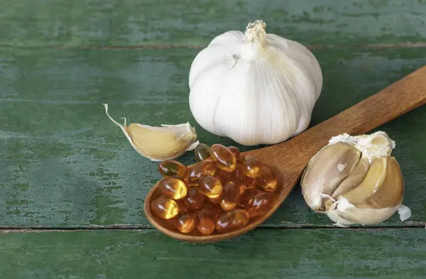 Garlic Bulbs Garlic Cloves Capsules Oil Extract Wooden Spoon Old Stock Picture