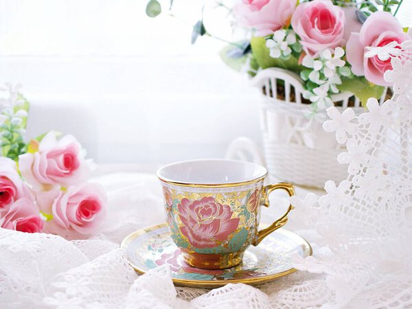 Antique cup of tea with pink rose on white background ,English tea vintage tone Valentine's day romantic ,Mother's day ,pretty background ,Chinese traditional ,coffee cup ,porcelain teacup 