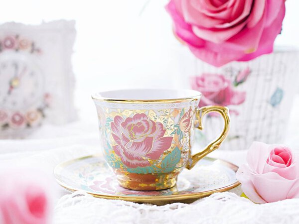 Antique cup of tea with pink rose on white background ,English tea vintage tone Valentine's day romantic ,Mother's day ,pretty background ,Chinese traditional ,coffee cup ,porcelain teacup 