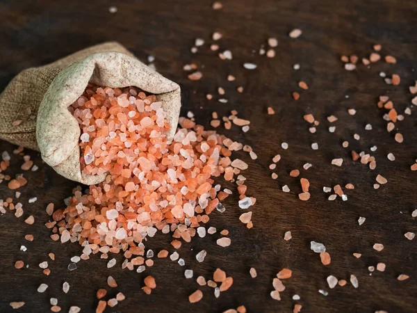 Himalaya Salt in Hemp sack on Wooden Background,Pink Salt Raw Food,Raw Food Ingredients Salty, for Cooking and Aroma Therapy,Food for Good Health concept.