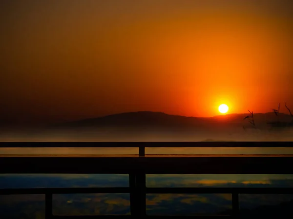 夜の黄金の霧とシルエット木製バルコニー 美しさサンライトオレンジ雲空自然背景 山の風景と反射ホライズン日の出 観光旅行休暇休日 — ストック写真