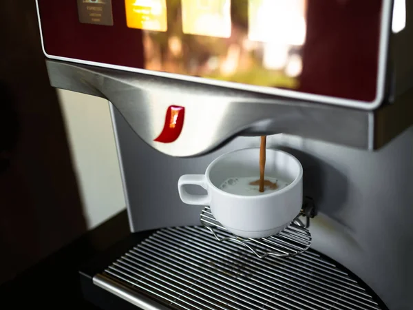 Coffee Purring from Automatic Coffee Machine in White Cup,Professional Barista Make Espresso at Cafe Bar Restaurant Resort Hotel,Late Hot Drink,Breakfast in Morning,Food have Caffeine.