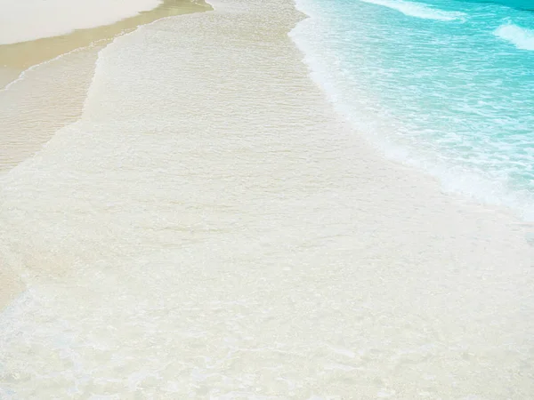 ビーチサンドの背景の海 白い泡水波青い海自然夏 砂の上の海岸テクスチャ穏やかな海景島 ツーリズムリラックス休暇旅行休日の風景パラダイススペース — ストック写真