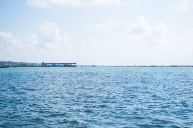 Travel Nature Concept, Sea Background Shore Blue Water at Coast Season Summer Tropical Ocean Beautiful Wave Seascape Vacation Smooth Wallpaper Island Outdoor Tropical Coast Sandy Nature Landscape.