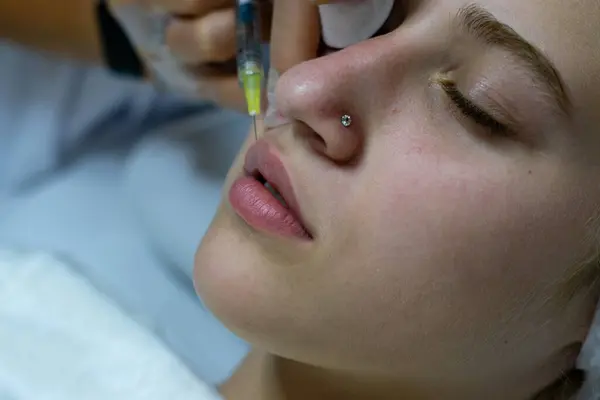 Filler injections for lips in beauty salon
