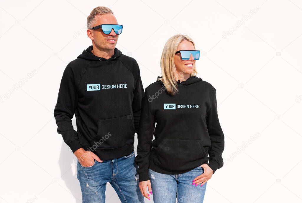 Woman and man wearing black hoodies, mockup for your custom hoody sweatshirt design