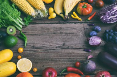 yellow, green, orange, red, purple fruits and vegetables on wooden background.  Healthy food. Multicolored raw food. Copy space