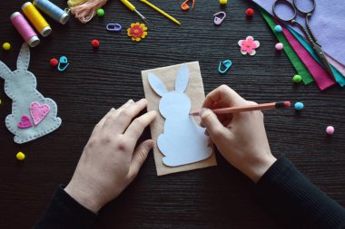 Çizim deseni tavşanı süsü, Paskalya el işi çalışma alanı, DIY projesi, makas, iplikler, renkli düğmeler, yaratıcı süreç, el yapımı dekorasyon, bahar tatili hazırlığı