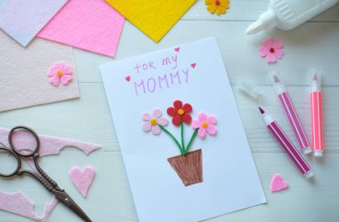 El yapımı anneler günü tebrik kartı oluşturma. Keçeli Çiçekler, Renkli Kağıt ve Beyaz Tahta Arkaplanda Makas Projesi. Annem için Yaratıcı Tatil Hediyesi Fikri, El işi Malzemeleri ile Kartvizit Yapımı Süreci