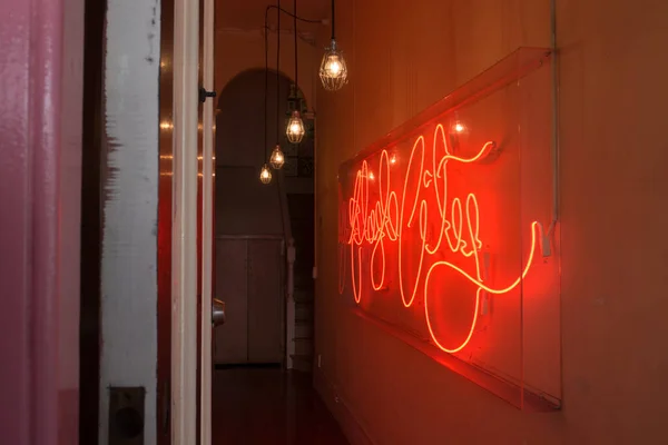 stock image Red neon lighting and gold light bulbs in a hallway advertising business