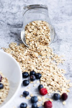 Oatmeal flaking with fresh blueberries, on a concrete background. healthy eating