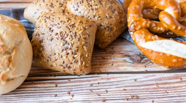 buns with seeds on a daily table, on a rustic wooden background.