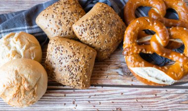 buns with seeds on a daily table, on a rustic wooden background.