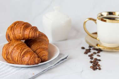 Morning with a cup of coffee and croissants. On a white background. Breakfast.