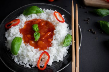 Tatlı ve ekşi soslu pilav. Akşam yemeği. Siyah bir arkaplanda