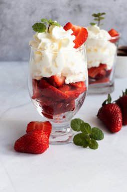 Krem şanti ve taze çilekten tatlı. hafif bir arkaplanda