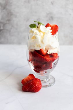 Krem şanti ve taze çilekten tatlı. hafif bir arkaplanda