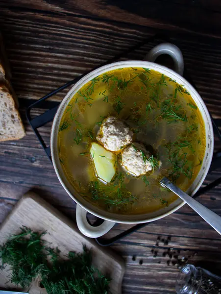 stock image Soup close-up. Soup with meatballs. On a wooden background.