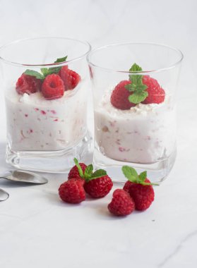 Yoğurt ve ahududulu tatlı. Lezzetli. Beyaz bir arkaplanda