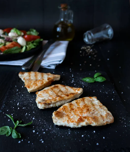 stock image Salad with chicken fillet and lettuce. on a black background.