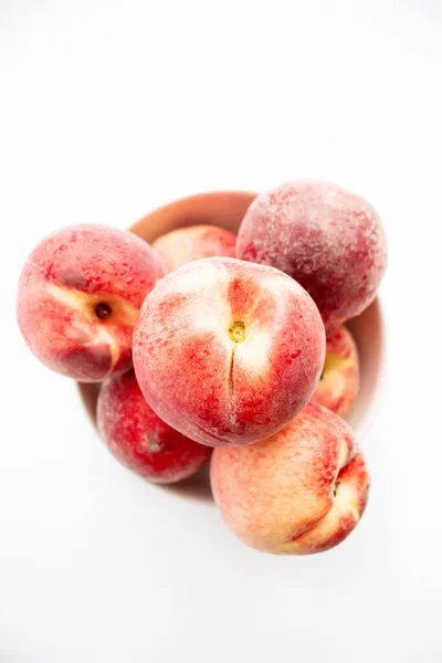 Stock image ripe peaches on a white background. top view. close up. fresh peaches in a bowl on a white background.