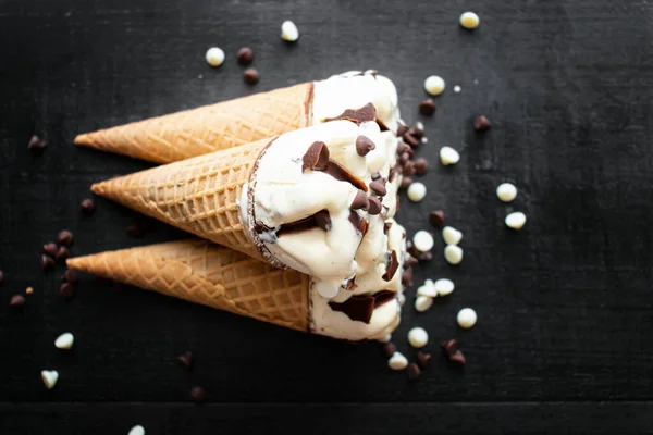 stock image Cream ice cream cone, cream with pieces of chocolate. On a dark background