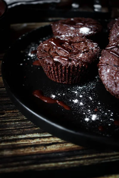 chocolate muffins with chocolate chips. dark background, copy space