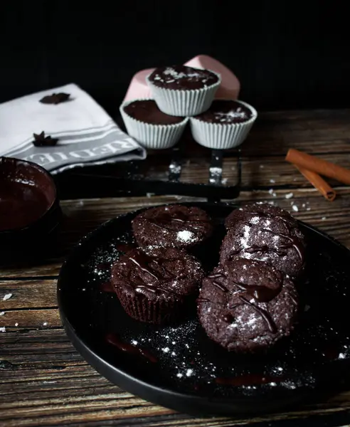 chocolate muffins and chocolate on a black table with a cup of coffee