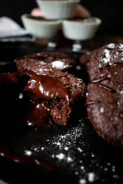 chocolate muffins with a chocolate on a black background
