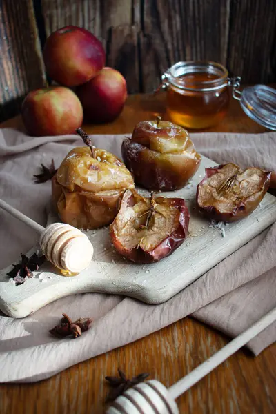 Baked apples with honey and cinnamon. on a wooden background. dessert