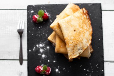 pancakes with chocolate on a white plate.