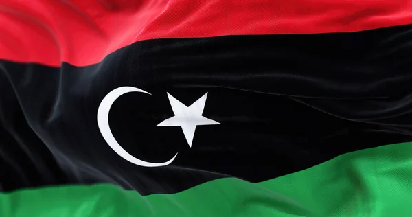 リビア国旗を手を振っのクローズアップビュー リビアは北アフリカの国です 生地の質感の背景 選択的焦点 — ストック写真