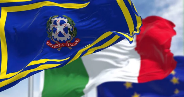Rome, It, October 2022: the flag of the Italian Prime Minister waving with the flags of Italy and the European Union blurred in the background