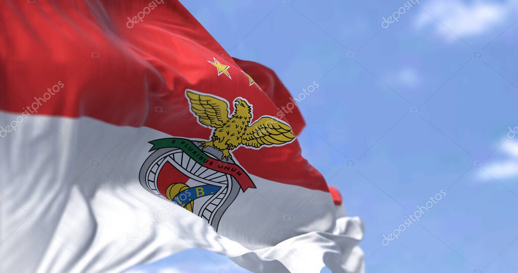 Lisbon, PT, Oct. 2022: The flag of SLB Benfica waving in the wind. Benfica is a Portuguese sports club based in Lisbon, Portugal, in the province of Sao Domingos de Benfica