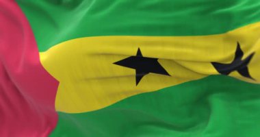 Sao Tome ve Principe ulusal bayrağının rüzgarda dalgalanmasını yakından izliyoruz. Kumaş desenli arka plan. Seçici odaklanma. Yavaş çekimde kusursuz döngü. 3 Boyutlu Hazırlama