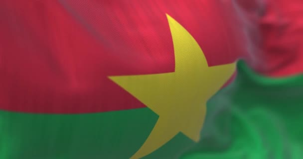 ブルキナファソ国旗が手を振っている様子が間近で見られます ブルキナファソは西アフリカの国です 生地の質感の背景 選択的フォーカス スローモーションでシームレスにループします 現実的な3Dレンダリング — ストック動画