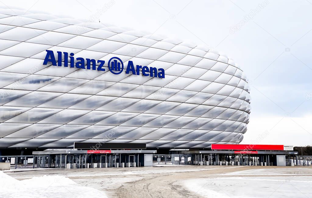 Munich, DE, Dec 2022: view of the exterior of the Allianz Arena in Munich on a cloudy day. The membrane covering the stadium illuminates in different colors depending on the event taking place inside.