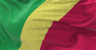 Close-up of the Republic of the Congo flag. Diagonal yellow band, green and red triangles on hoist corner. Rippled fabric. Textured background. Selective focus. Realistic 3D render. Slow motion loop