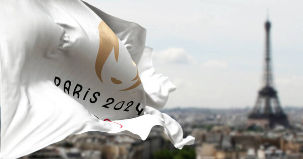Paris, FR, Jan 2023: Close-up view of the Paris 2024 Summer Olympics flag waving in the wind with blurred Paris skyline on the background. Realistic 3d illustration. Illustrative editorial