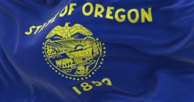 Close-up of the Oregon state flag waving. Oregon is a state in the Pacific Northwest. Selective focus on the coat of arms. Rippled fabric. Realistic 3D render. Slow motion loop
