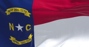 Close-up view of the North Carolina state flag waving. North Carolina is a state in the Southeastern region of the United States. Rippled fabric. Textured background. Realistic 3d Render