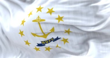 Close-up of the Rhode Island state flag waving. Gold anchor in the center surrounded by thirteen gold stars. Selective focus. Rippled fabric. Realistic 3D render. Slow motion loop