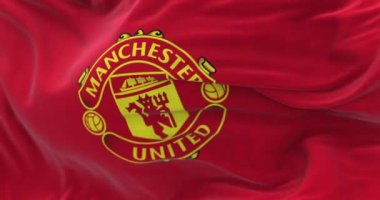 Manchester, UK, jan 2023: The flag of Manchester United waving. Manchester United FC based in Old Trafford. Selective focus. Rippled fabric. Realistic 3D render. Slow motion loop