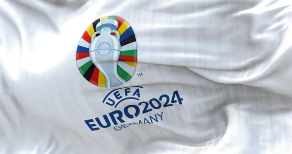 Berlin, DE, October 2022: UEFA Euro 2024 flag flying. The 17th edition will take place from 14 June to 14 July 2024 in Germany. Selective focus. International sport event. 3D illustration