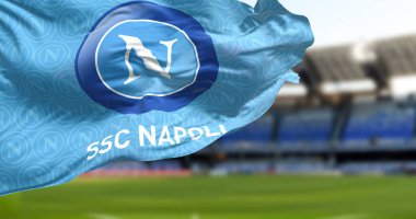 Naples, IT, Jan 2023: The flag of SSC Napoli waving with the Diego Armando Maradona Stadium blurred in the background. Italian football team based in Naples. Realistic 3d illustration. Rippling fabric clipart