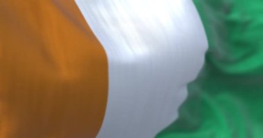 Detail of of Ivory Coast National flag waving. Orange, white, green vertical stripes. West African State. Fluttering textile. Selective focus. 3d render animation. Slow motion loop. Close-up