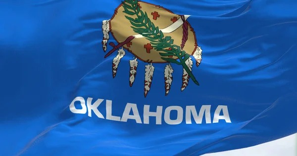 Close up view of the Oklahoma state flag waving. Oklahoma is a state in the South Central region of the United States. Rippled fabric. Textured background. Realistic 3d illustration. Close-up. Selective focus